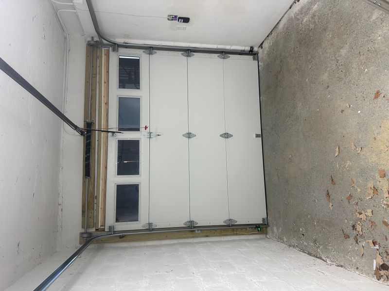 Commercial white sectional door with vertical window inserts interior view — MA
